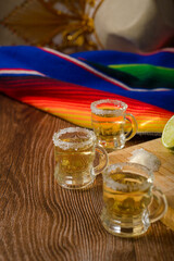 Tequila shots with salt and lime on a bar table. Shots of tequila and typical mexican elements.