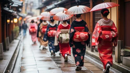 Foto op Plexiglas A Group of Geisha Walking and Holding Umbrella in Rainy Season Kyoto Japan © Paniti