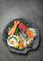 mixed sashimi plate in japanese restaurant on grey background - 661748043