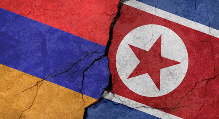 Flags of Armenia and North Korea, concrete wall texture with cracks, grunge background, military conflict concept