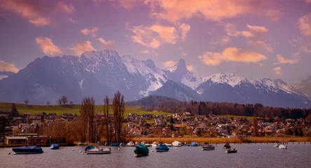 Fototapeten The mountain sunset view with alpine as snow-capped mount peaks and lake in  Winter mountains © SASITHORN