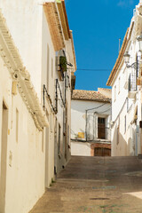  Narrow street with white old houses, spanish mediterranean town, in Teulada (Alicante, Spain).