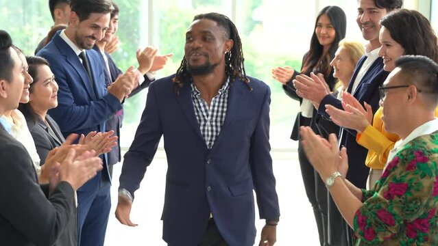 Multiracial group of diversity business people in row applauding or clapping hands to congratulate  boss african american winner walking to success achievement goal.