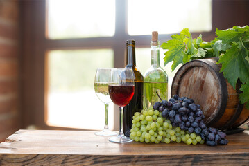 red wine bottle and wine glass on wodden barrel. High quality photo