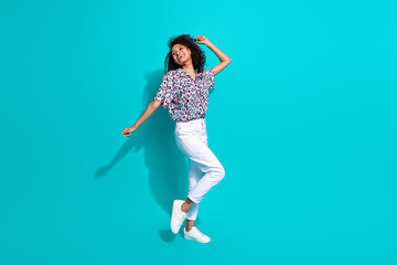 Fototapeta na wymiar Full length photo of positive girl stylish clothes enjoy summer vacation holiday look up empty space isolated on cyan color background