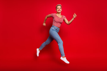 Fototapeta na wymiar Full length photo of cheerful positive girl wear trendy clothes hurrying store special seasonal offer isolated on red color background