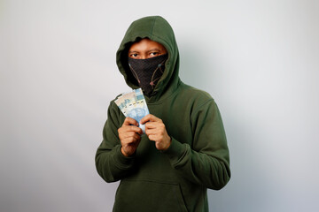 Thief holding paper money isolated on white background.