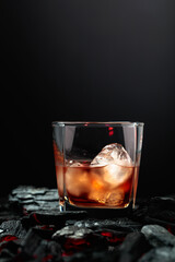 Whiskey with ice in dampened glass.