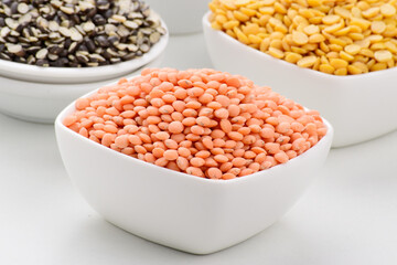 Closeup of red lentils in bowl, raw legume