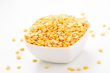 Closeup of raw chana dal in bowl on white background