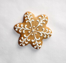 White snowflake gingerbread with icing on a white background. Christmas Conception. Isolated