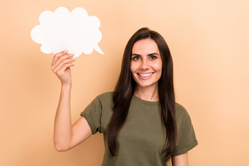 Photo of cheerful charming girl dressed khaki t-shirt rising mind cloud empty space isolated beige color background