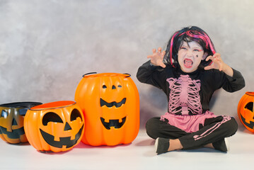 Pretty little girl dressing up as a witch in a Halloween setting - 661792258