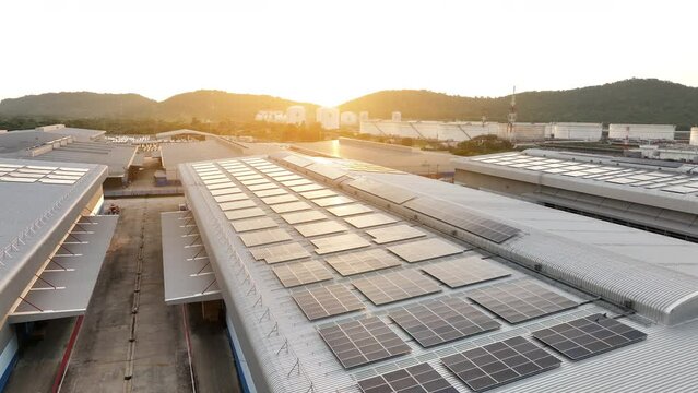 Top view Solar Panels on Warehouse Factory. Solar photo voltaic panels system power or Solar Cell on industrial building roof for producing green ecological electricity. Production of renewable energy