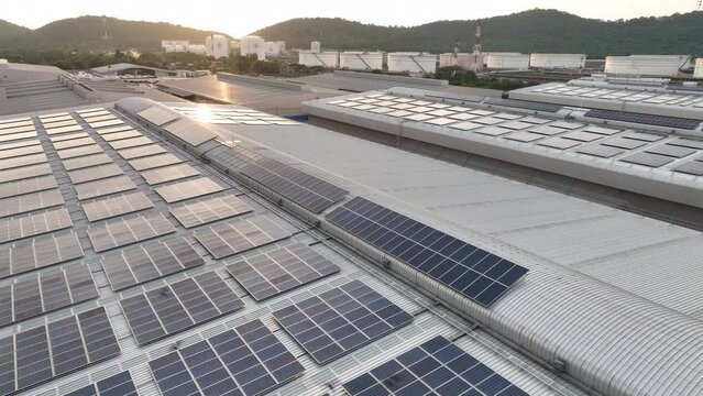 Top view Solar Panels on Warehouse Factory. Solar photo voltaic panels system power or Solar Cell on industrial building roof for producing green ecological electricity. Production of renewable energy