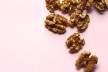 Walnut kernels on pink background