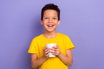 Photo of cheerful adorable boy wear trendy clothes drinking delicious beverage morning breakfast isolated on purple color background