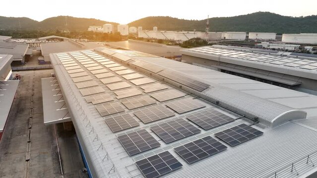 Top view Solar Panels on Warehouse Factory. Solar photo voltaic panels system power or Solar Cell on industrial building roof for producing green ecological electricity. Production of renewable energy