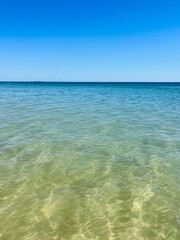 Obraz premium Blue sea horizon, transparent sea surface with ripples, clear blue sea and blue sky