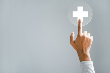 A hand touches a plus icon, emphasizing health, medicine, and insurance. Portrays a protective family business concept. Highlighting hospital access, welfare health service.