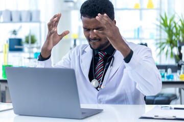 Angry Scientist. Scientist or pharmacist using laptop computer in modern Lab office. Scientist Man...