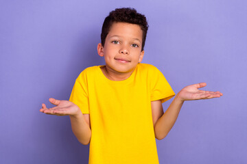 Photo of puzzled boy wear yellow trendy clothes hands demonstrating gesture no answer dont know...