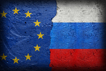 European Union and Russia flag on broken concrete wall background