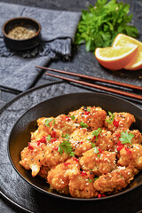 crispy orange cauliflower florets in black bowl