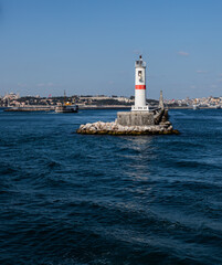 white lighthouse with red line in the sea, Istanbul