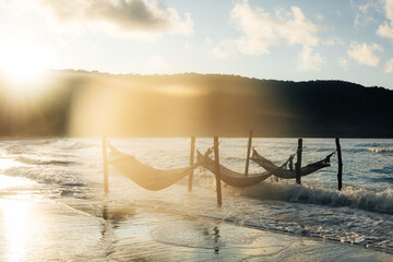 Empty cradle on the beach with beautiful sunlight and sea in the background.