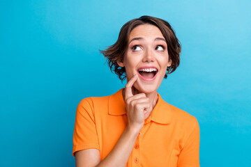 Photo of adorable excited lady wear orange t-shirt finger open mouth looking empty space isolated...