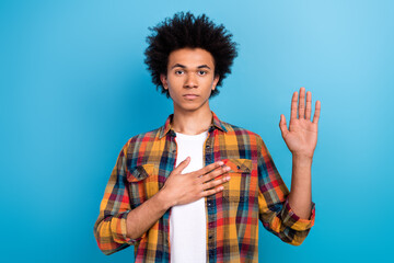 Photo of serious confident guy dressed checkered shirt swearing tell only truth isolated blue color background - obrazy, fototapety, plakaty