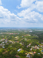 Aerial View of Pekanbaru city skyline with many trees in Indonesia. The capital city of Riau province with many residential buildings.