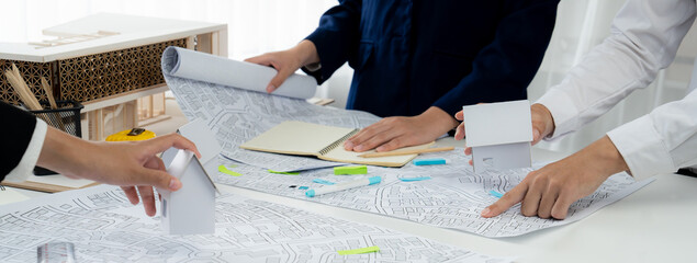 Worker, architect and engineer work on real estate construction project oratory planning with...