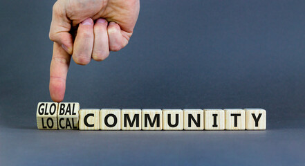 Global or local community symbol. Concept words Global community Local community on wooden blocks. Beautiful grey background. Businessman hand. Business Global or local community concept. Copy space.