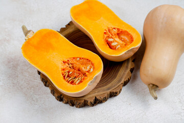 Halves of raw pumpkin or butternut squash.