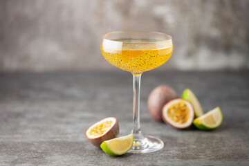 Passion fruit martini cocktail. Sour alcoholic drink with fresh passion fruit and lime, with bar...