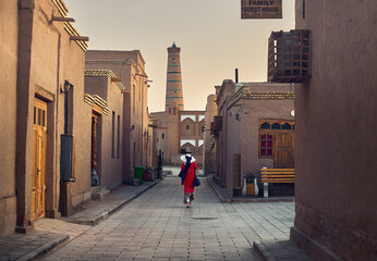 Woman in old town Khiva at the sunrise in Uzbekistan
