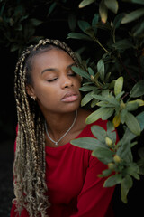 Close up portrait of a young beautiful  woman near the green trees