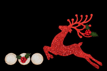 Christmas Eve reindeer sparkling red tree ornament on black with holly and mince pie snacks. Festive symbols for greeting card, gift tag, label.