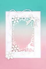 Fantasy Christmas eve reindeer and bauble decorations with abstract snow on white frame on green and pink background. Magical North pole theme for holiday season.
