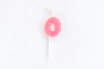 Pink candle number 0 on cement wall background, Birthday candle