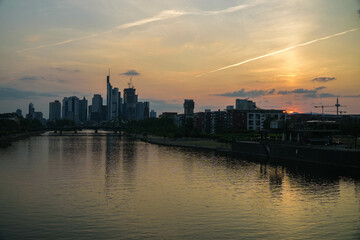sunset time in frankfurt city. panorama view above the main river and in the backround the skyline in the evening sky