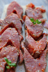 Red fish is cut into steaks and covered in creamy sauce.