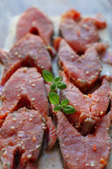 Red fish is cut into steaks and covered in creamy sauce.