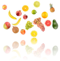 Falling colorful vegetables and fruits with light reflection isolated on white