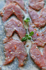 Red fish is cut into steaks and covered in creamy sauce.