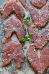 Red fish is cut into steaks and covered in creamy sauce.