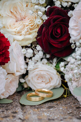 Beautiful wedding rings and flowers close up, macro photo