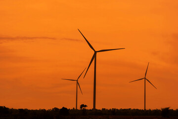 View of wind farm, with high wind turbines for generation electricity . Green energy concept.